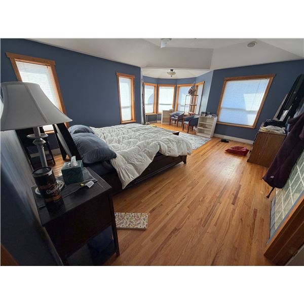 large bedroom lot includes the wood bed frame, nightstands, seating, dresser, and decor items