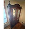 Image 1 : Ornate Wooden Display Cabinet with Glass Doors, Woven Accents, and Decorative Finials