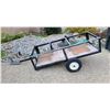 Image 1 : Single-axle utility trailer with a black metal frame