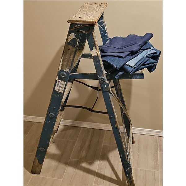 Wooden Step Ladder with Paint Splatter and Folded Denim Fabrics