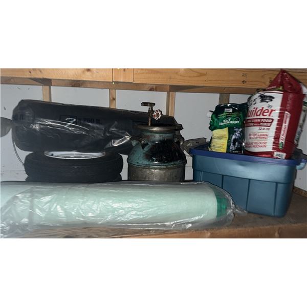 Garage Lot with Tires, Milk Can, Lawn Fertilizer, and Blue Storage Bin