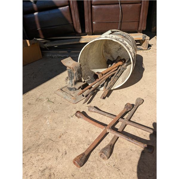 Bucket of spare wheel wrenches with jack