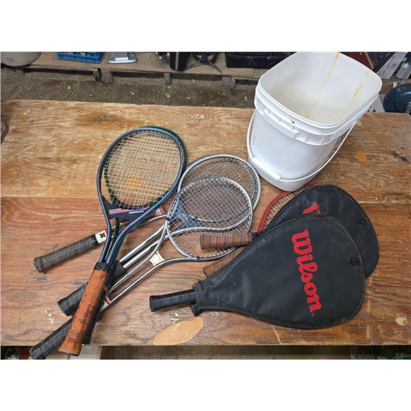 Lot of tennis rackets and bucket