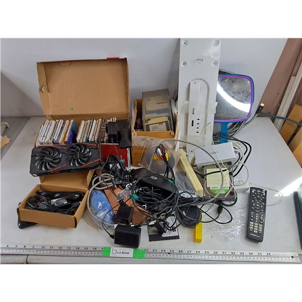 Assorted CDs, Floppy Discs, MakeUp Mirror, Power Bar, Gigabyte Video Card, Remote, Misc