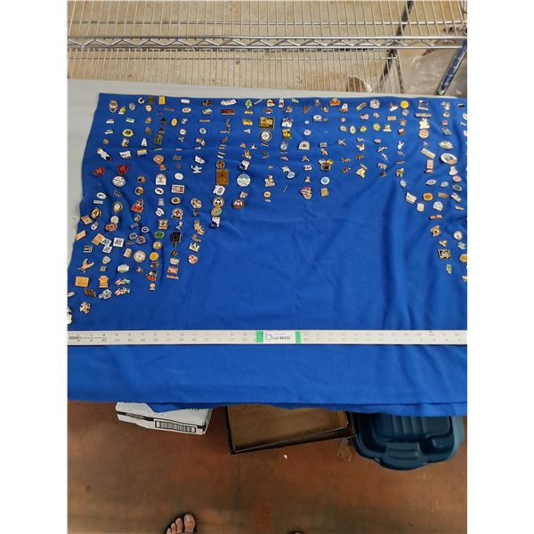 Large Assortment of Souvenir,Travel and Club Lapel Pins on a Blue Cloth