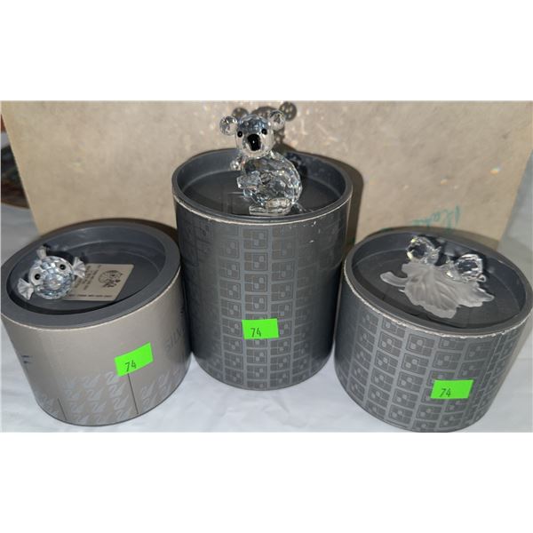 Swarovski Crystal Figurines Including Koala, Lion, and Fish with Original Cylindrical Boxes