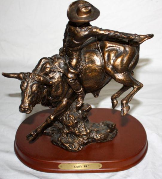 Bronze Statue Of A Cowboy Riding A Bull
