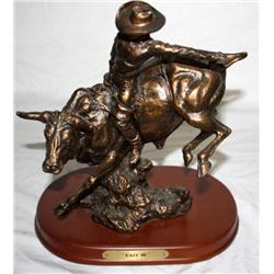 Bronze Statue Of A Cowboy Riding A Bull