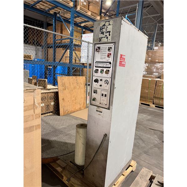 Economaster turntable stretch wrapper, which is an industrial machine used to wrap pallets with plas — image 3