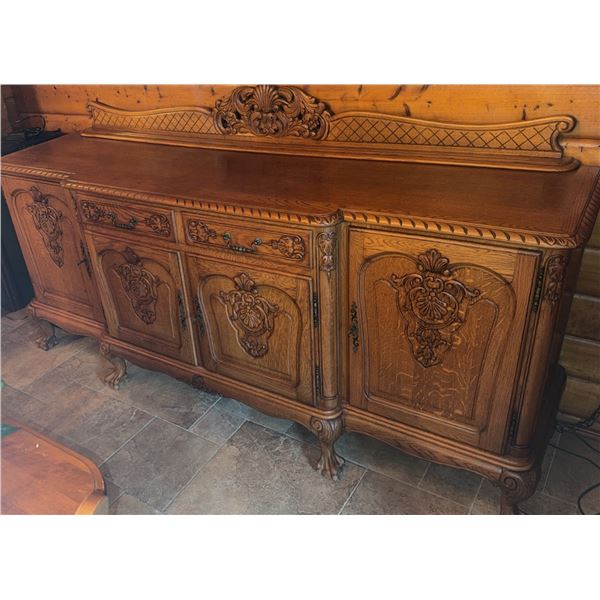 Carved Oak Sideboard with Ornate Detailing and Brass Handles