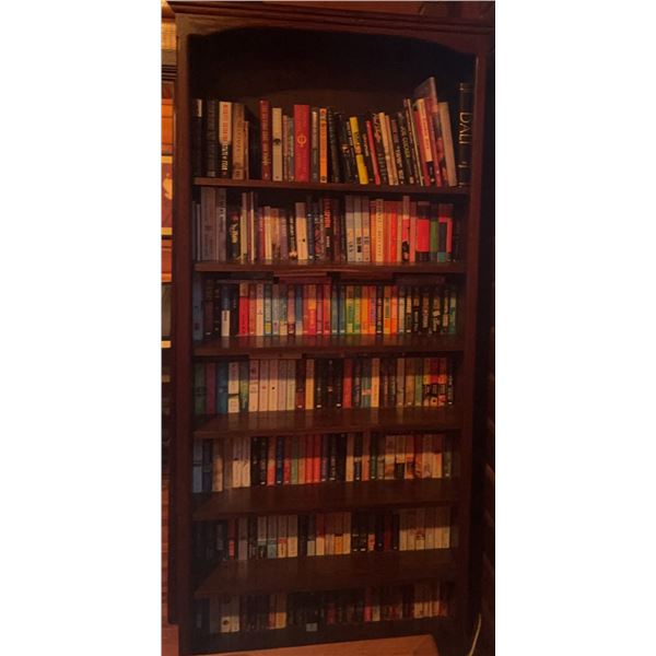 Tall Wood Bookcase with Assorted Hardcover and Paperback Novels