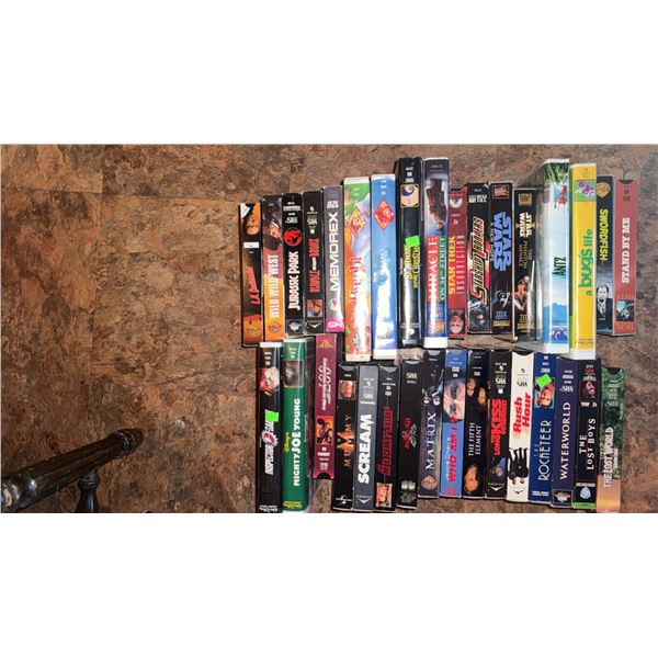 VHS Movie Tapes Including Jurassic Park, Rocky, Scream, Waterworld