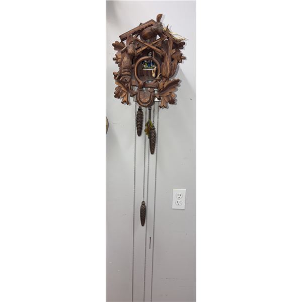 Carved Wood Cuckoo Clock with Animal Motifs and Rotating Figurines