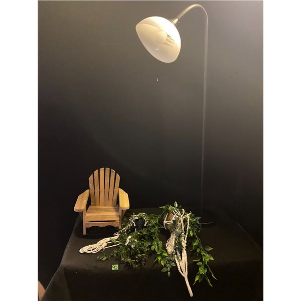 Home décor items including artificial plants and floor lamp