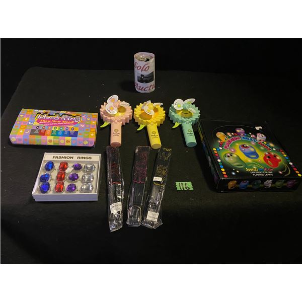 Lot of gift shop items including children's fashion rings, mood rings, fans and more