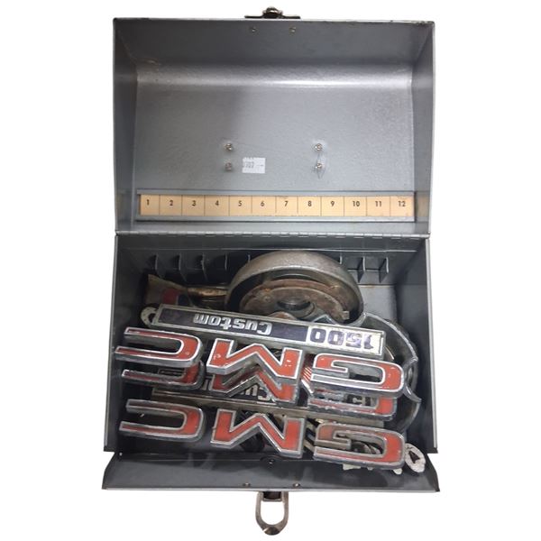 Collection of vintage truck emblems with metal box