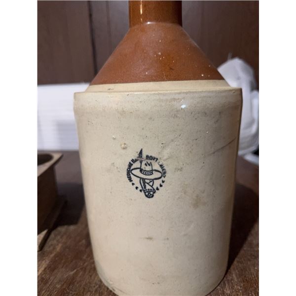 MedAlta Pottery jug made in Medicine Hat. Features a brown glazed upper section, sturdy handle, and 