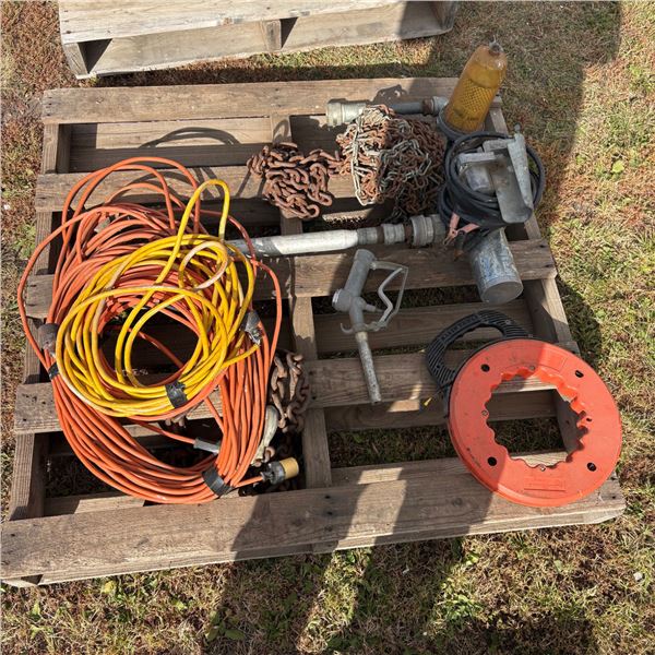 Pallet of extentions cords, tire chains, large logging chain, gas nozzle / gas pump