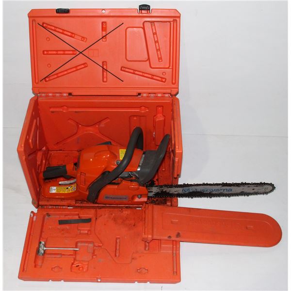HUSQ VARNA CHAIN SAW IN A ORANGE CASE