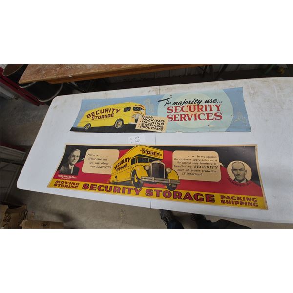 Two Security Storage Cardboard Advertising Signs with Yellow Moving Vans