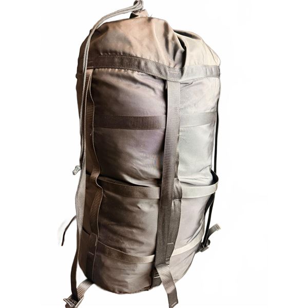 Black Compression Sack with Yellow Sleeping Bag Inside