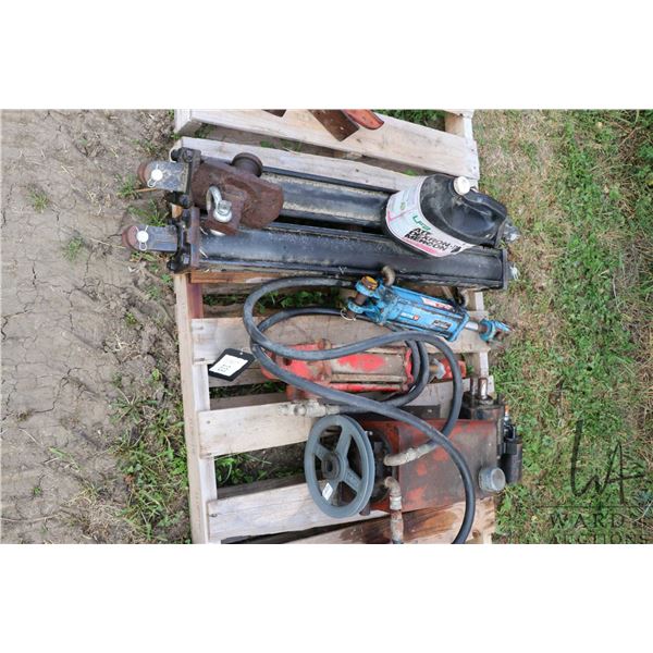 Hydraulic rams, two matching and the other connected to a pump