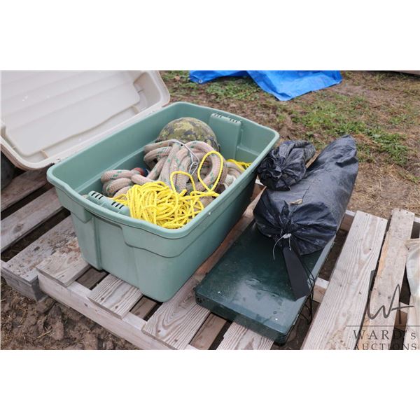 Military helmet, heavy cord, rope, tent, camp stove