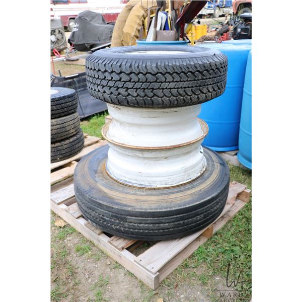 Two 22.5" rims, one Michelin 10R 22.5 XZE tire and GM marked alloy 8 bolt rim fitted with Michelin L