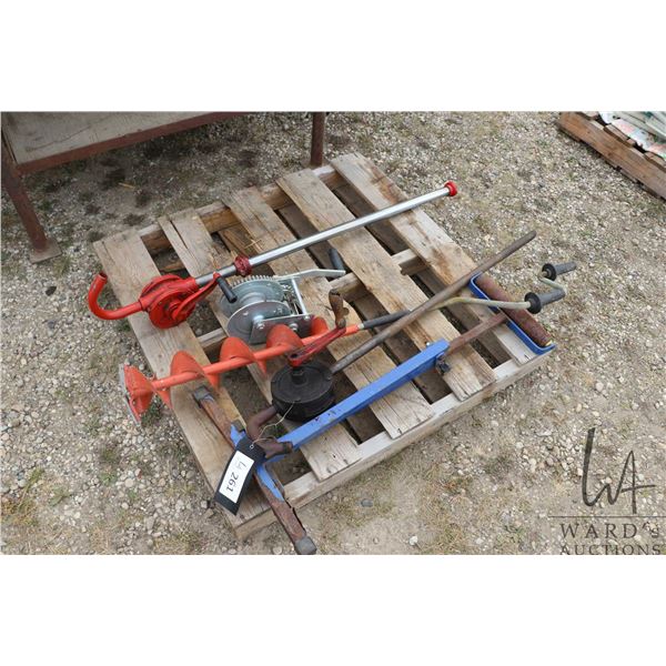 Ice auger, two fluid pumps and a roller stand
