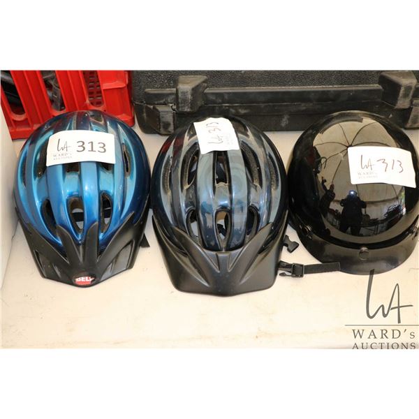 Two bicycle helmets and one small size motorcycle helmet