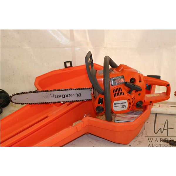 Husqvarna model 235 chain saw with case, engine turns freely and has compression
