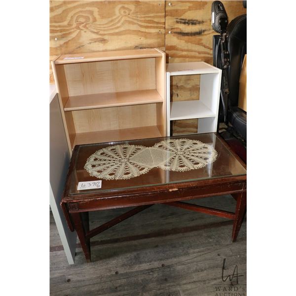 Two open wooden shelves and an antique coffee table