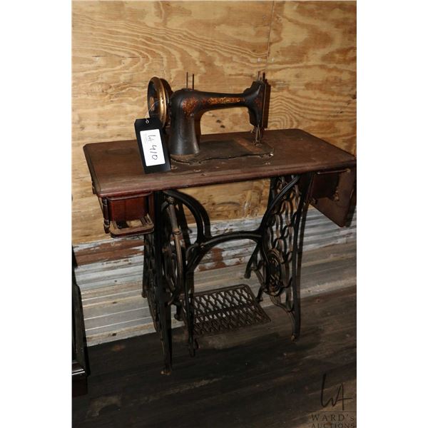 Antique Singer sewing machine in treadle cabinet