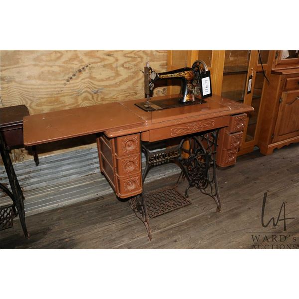 Antique Singer sewing machine in painted cabinet