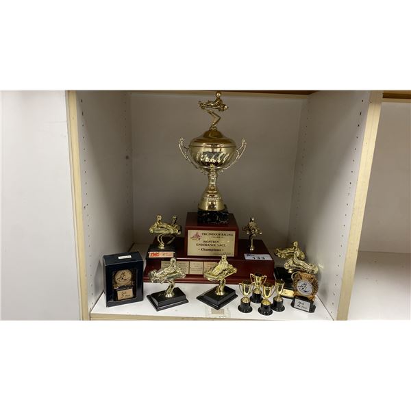 SHELF OF ASSORTED RACING TROPHIES