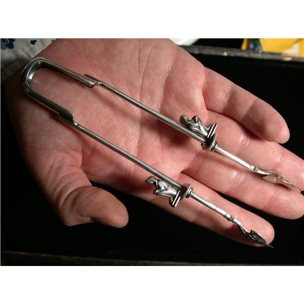 A fine Sterling Silver Sugar Tongs with Seated Egyptian Pharaohs