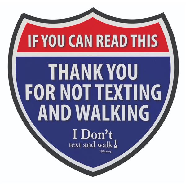 An "I Don't Text and Walk" Backstage Cast Member Sign.