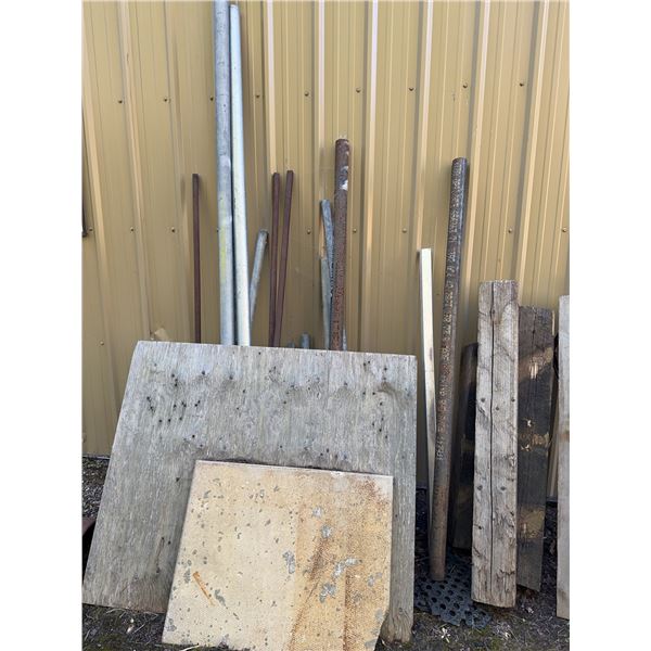 Scrap Lumber, Metal Poles, and Two 55-Gallon Plastic Barrels