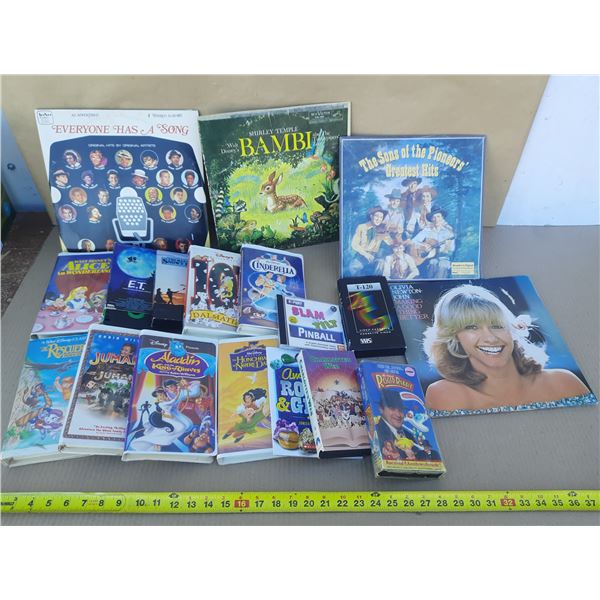 Collection of vintage items including Walt Disney VHS tapes, record albums, a cassette tape, and an 