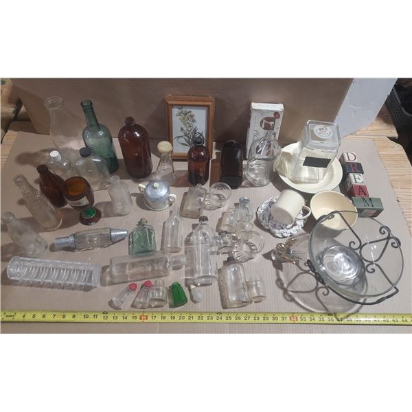 Collection of vintage and antique glass bottles, small apothecary vials, and decorative household it