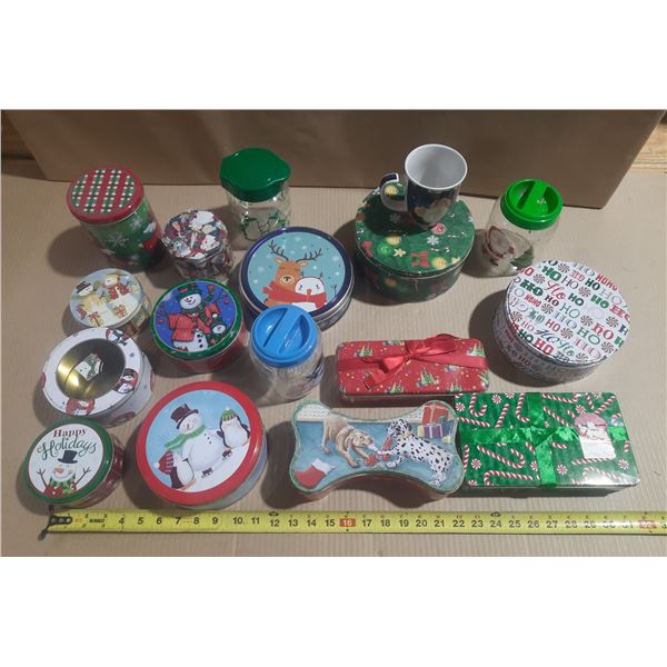 Assortment of decorative Christmas holiday tins, containers, and jars with festive designs like snow