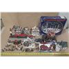 Image 1 : Collection of miniature Christmas village buildings, figurines, a train set, and a "Village Skating 
