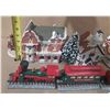 Image 6 : Collection of miniature Christmas village buildings, figurines, a train set, and a "Village Skating 