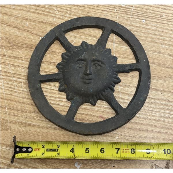 Brass Vintage cast iron sun face trivet featuring a charming, stylized smiling face surrounded by ra