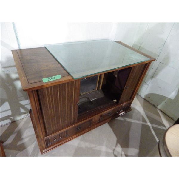 old TV converted to storage with miscellaneous Glass