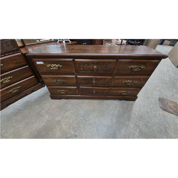 Dark Wood Dresser with 9 Drawers, Brass Hardware, and Carved Details. 64”×32”×18.6”