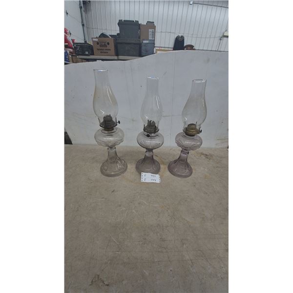 Three Glass Oil Lamps: Clear and Amethyst Glass, with Chimneys and Burners