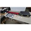 Image 1 : Red fishing rod Tube Case, Black Briefcase, 4 Pkgs Ice Grips, and Bee Playing Cards
