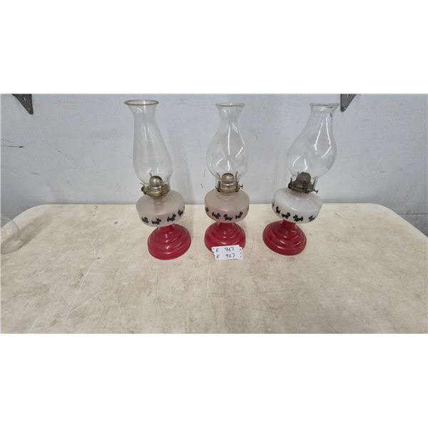 Three Vintage Oil Lamps with Scottie Dog Motif, Red Base and Clear Chimney