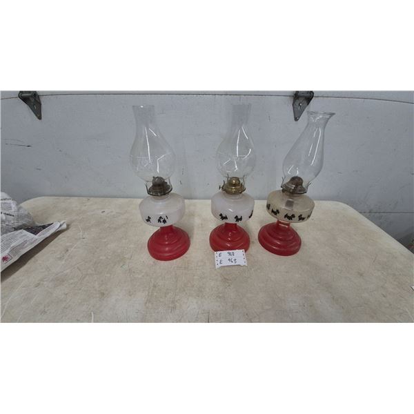 Three Oil Lamps with Red Bases and Scottie Dog Silhouettes